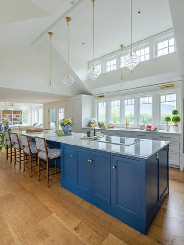 red oak in large vaulted ceiling kitchen with blue cabinets and white walls