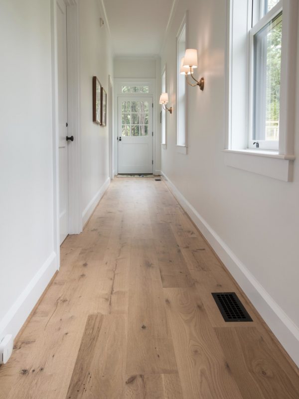 white oak floor in open white hallway