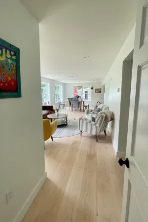maple flooring in hallway leading to living room