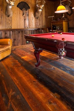 reclaimed heart pine in billard room with deer heads