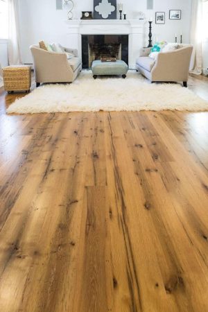 reclaimed oak floor with shag rug, fireplace, and two chairs